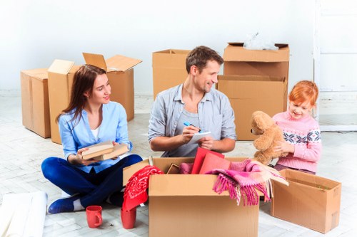 Moving team loading household items into a removal van