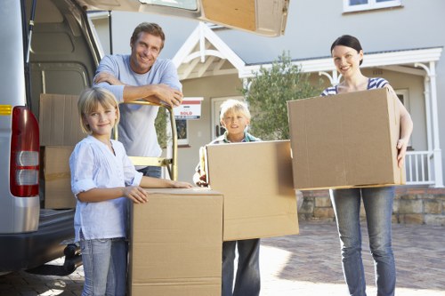 Furniture and boxes being loaded into a removal van