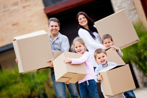 Removal vehicle and movers handling boxes in South West London